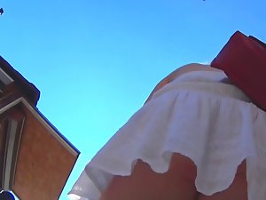 UPSKIRT Beautiful woman in white skirt and red thong